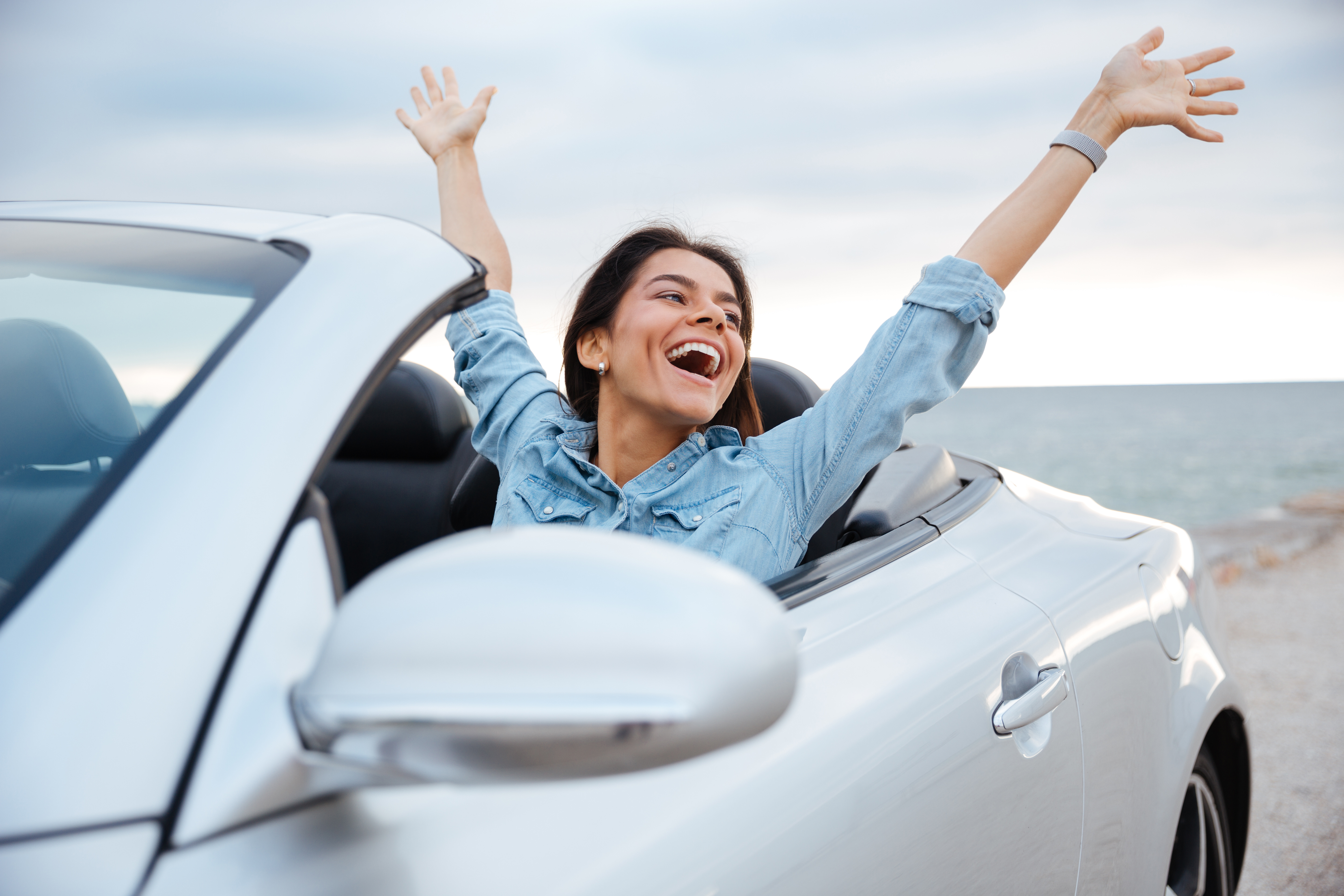 Woman happily driving car in Michigan